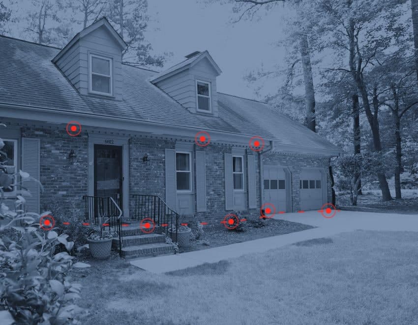 A home left untreated — red markers show the gaps at the foundation, garage doors and eaves where pests get in