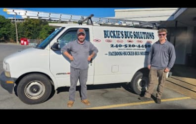 Buckie and Hunter beside the Buckie's Bug Solutions service van